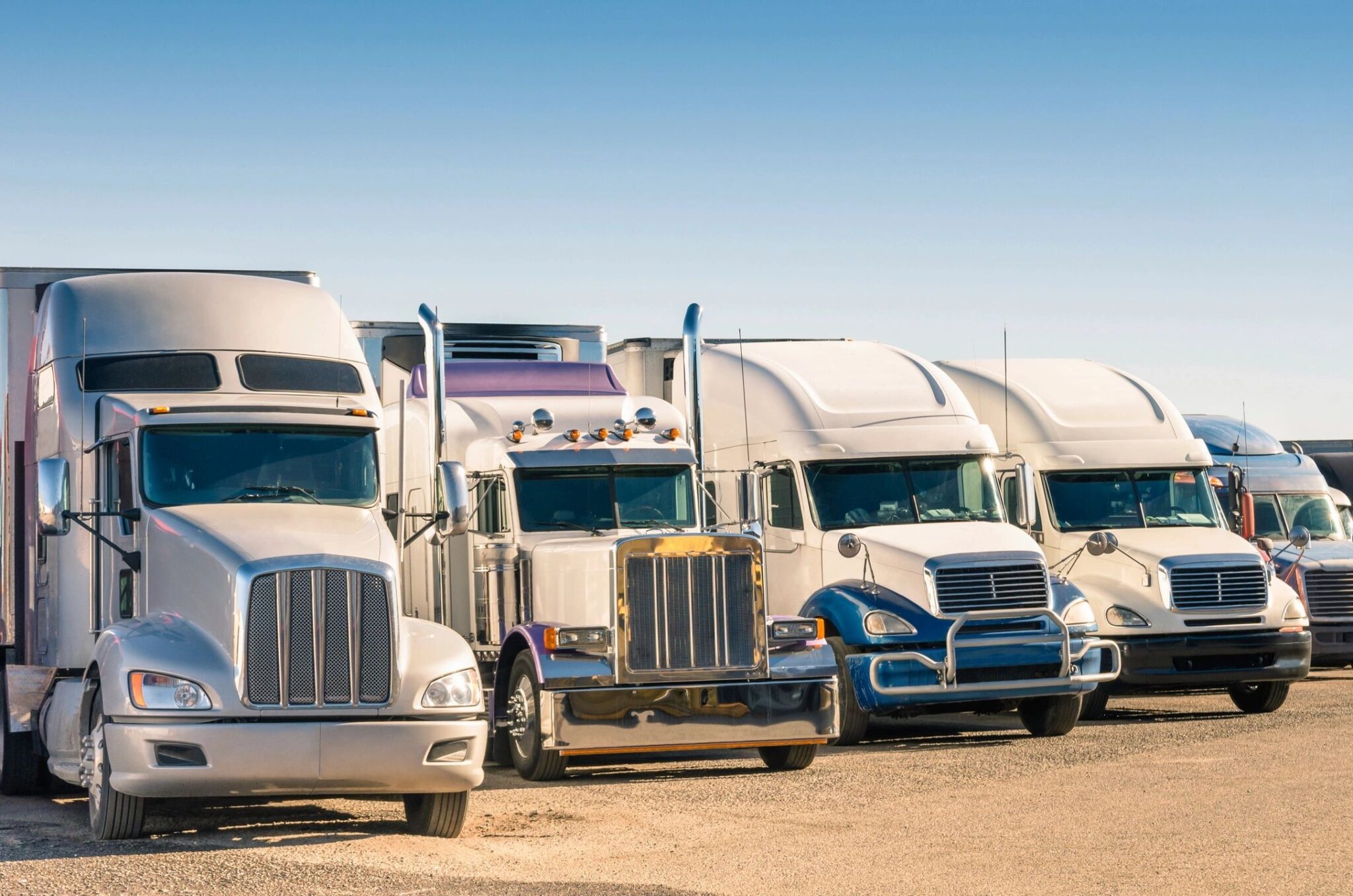 Commercial semi-trucks parked in a fleet lot